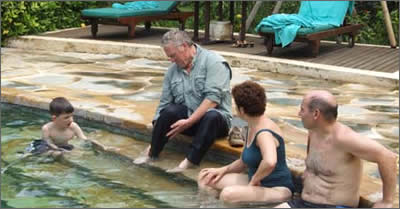 The brave traveller sticking his mucky feet in the pool